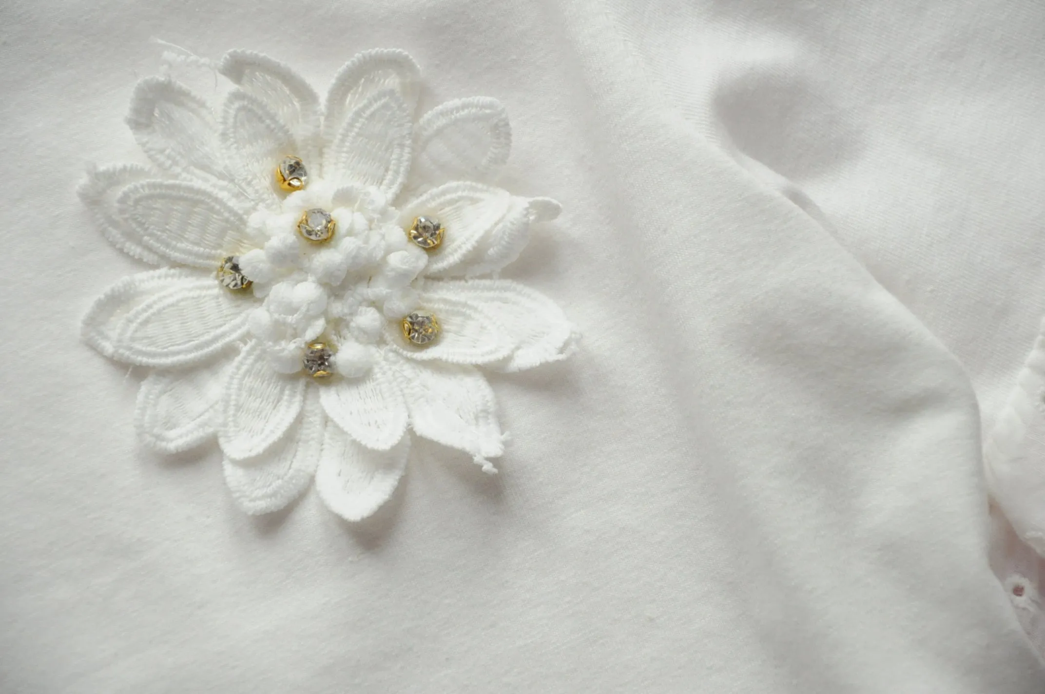Off white broderie anglaise frilled peplum tee with 3D gem flower detail